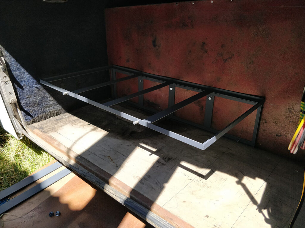 Frame for grey and black tanks built an under floor into storage compartment.