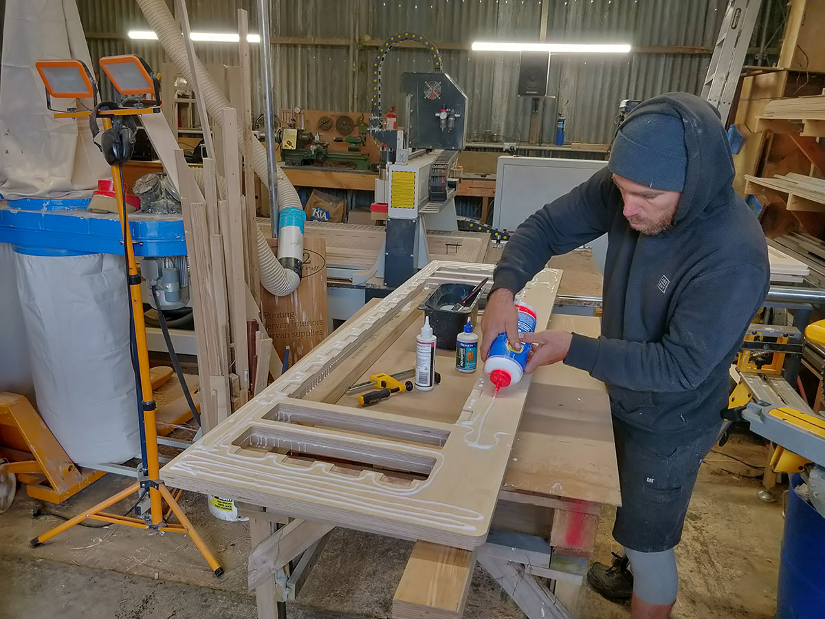 Leo gluing up the triple stack of ply parts that form the sofa & bunk bed bases.