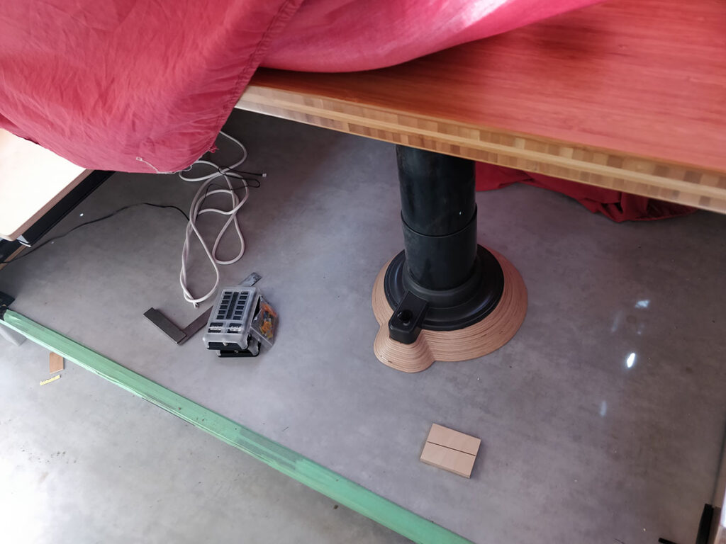 The table pedestal mounted to it's leveling wedge. 